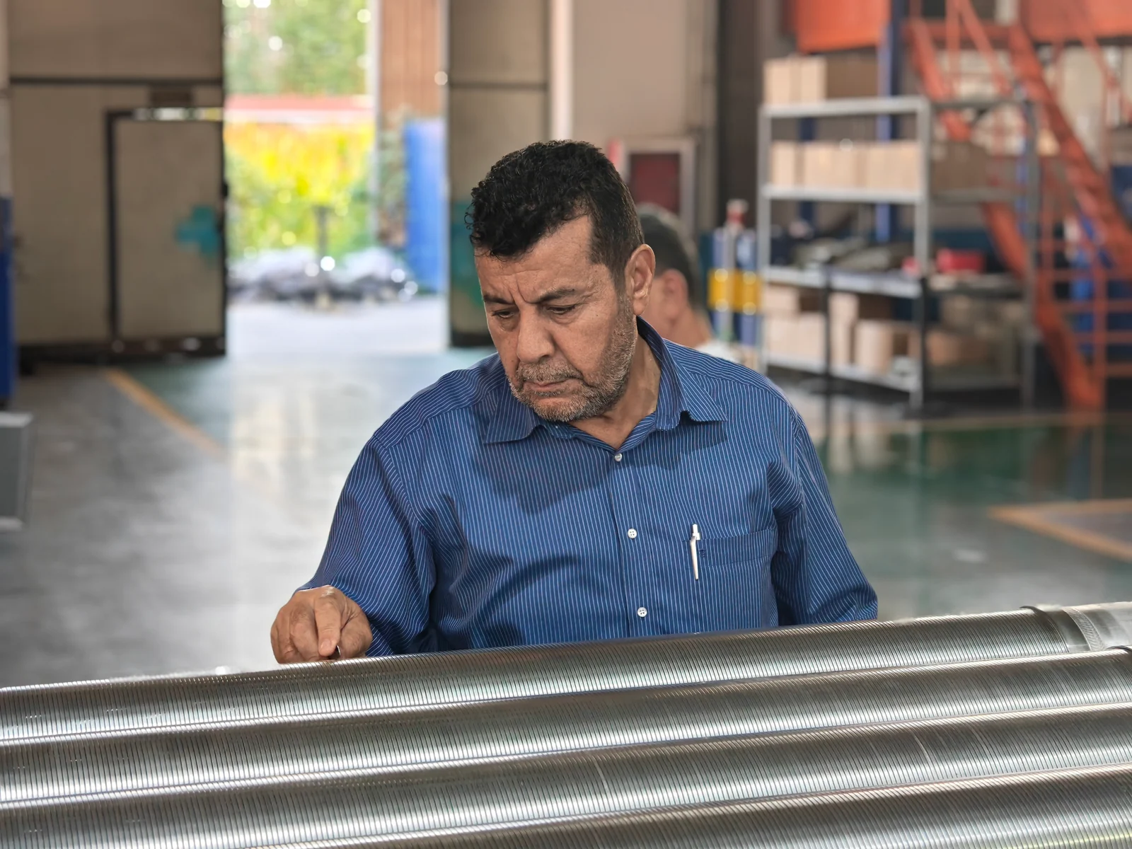 Customer checking the surface and continuous slots of stainless steel wire-wrapped screens